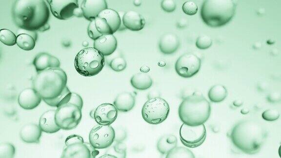 在绿色背景上上升的液体气泡