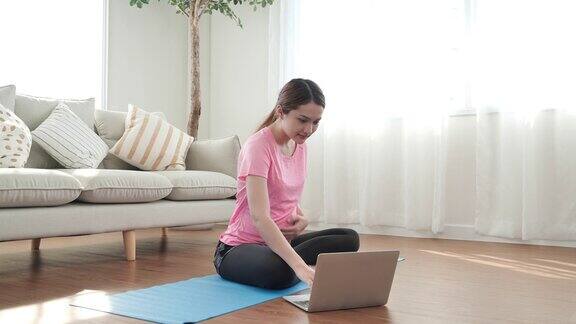 亚洲年轻孕妇在客厅做瑜伽普拉提锻炼