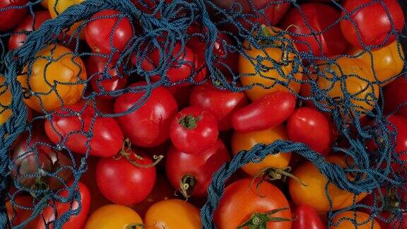 蔬菜成生态绳袋旋转背景可重复使用的纺织品零废物网袋黄红色的西红柿