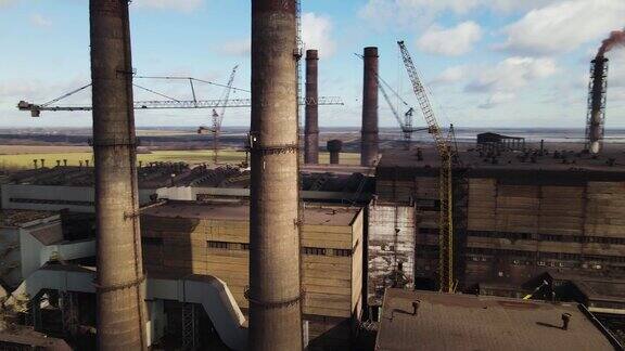 无人机拍摄的钢铁厂管道航拍画面在冶金厂的上空一团烟雾正从烟囱里冒出来