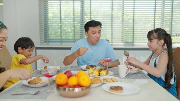 亚洲家庭在家里的餐桌上一起吃早餐