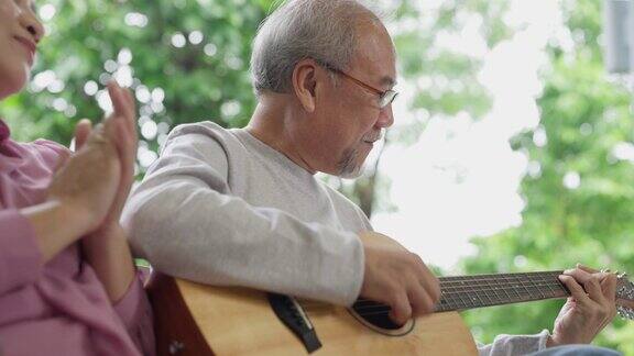 健康的退休老人在花园中伴着音乐享受