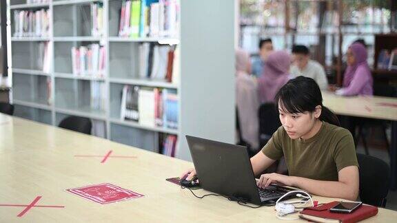 亚洲大学女学生在图书馆学习