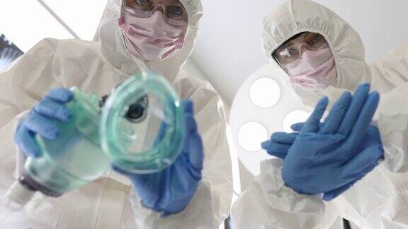 两名医生穿着防护服戴着口罩手持氧气面罩计划进行心脏按摩慢动作4k电影