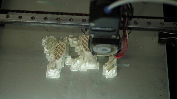 正在工作的3D打印机正在用白色塑料打印物体