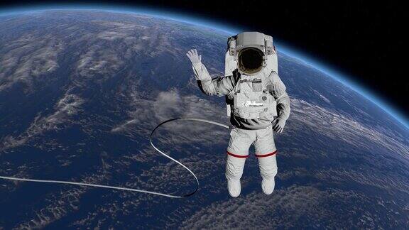 宇航员太空行走在空地上挥手国际空间站围绕地球大气层旋转这段视频由美国宇航局提供