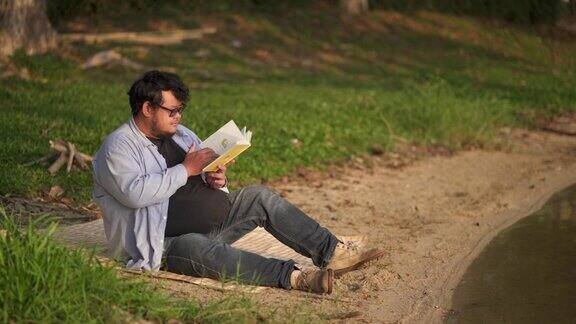 坐在沙滩上看书的男人