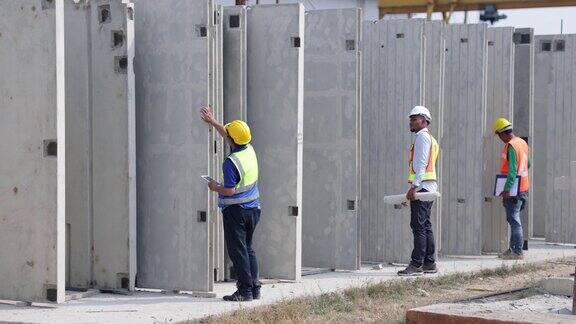 非裔美国建筑师工程人员和在预制厂工作的亚洲工人重工业制造厂预制混凝土墙
