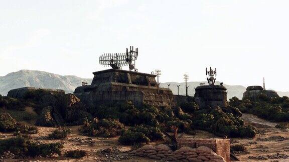 沙漠景观岩石和树木围绕着一个军事基地战争掩体