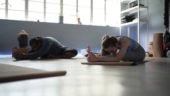 瑜伽教练和学生一起伸展和热身