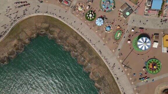 航拍无人机带着相机直接从星海广场的木板路上飞过