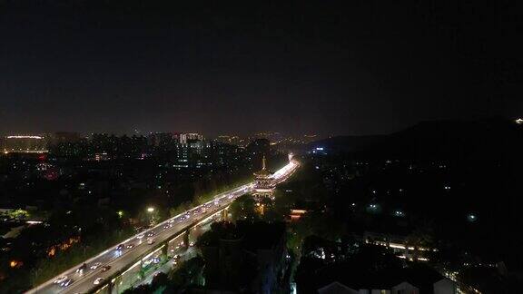 夜景时间照亮杭州城市交通道路边宝塔空中全景4k中国