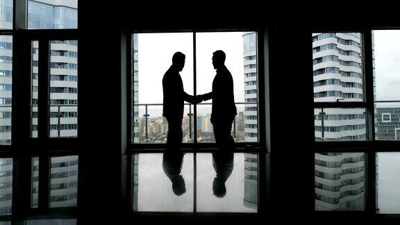 合作理念:两个男人剪影握手