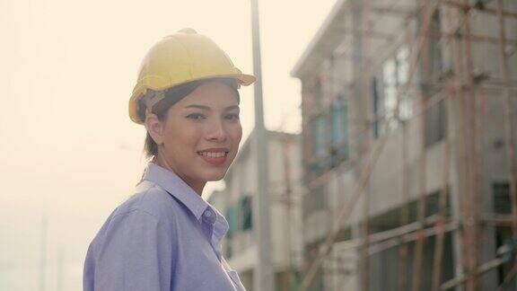 在房屋建设项目、开发项目现场的亚洲投资者和检查员微笑着对工作感到自豪