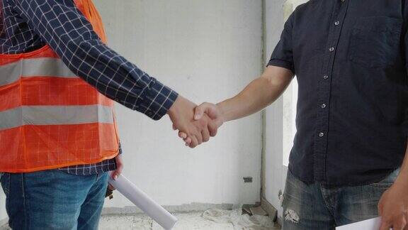 工程师在施工现场与工地业主握手