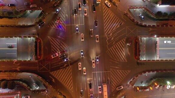 长沙市中心城区夜间灯光照亮交通街道十字路口高空俯视图4k中国
