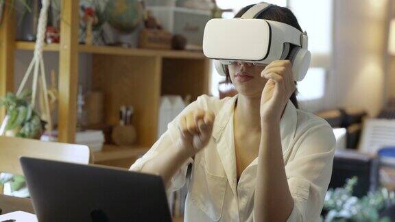 亚洲人在家使用虚拟现实模拟器工作