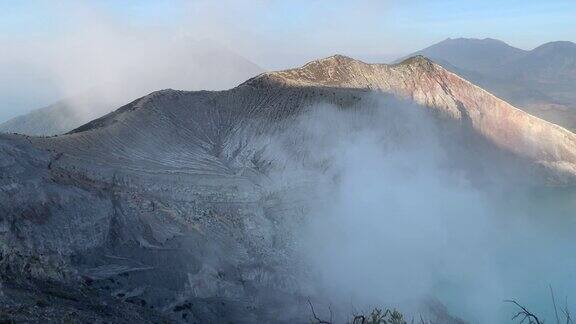 日出后卡瓦伊真火山口火山的岩石悬崖与绿松石硫磺湖水印尼东爪哇的旅游景点自然景观背景