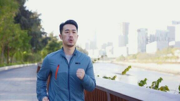 年轻的亚洲人在城市公园户外慢跑