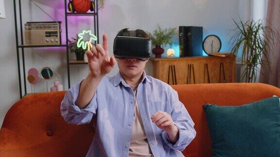 男子使用虚拟现实未来技术头戴式耳机在家玩模拟3D视频游戏