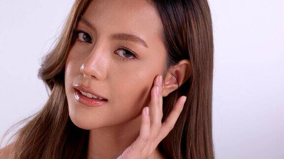美丽年轻的亚洲女性干净清新的皮肤在白色的背景面部护理面部护理美容美容和水疗亚洲女性肖像