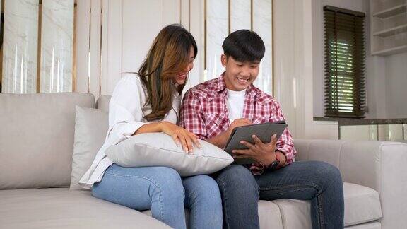 幸福的年轻夫妇用平板电脑和朋友聊天