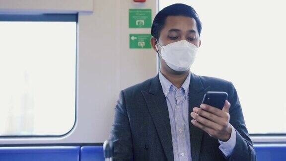 一名商人在地铁列车上用手机视频通话