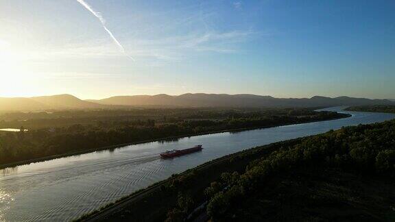 在一个秋天的早晨日出时分一艘经过的客船将法国南部罗纳河的河床全景尽收眼底