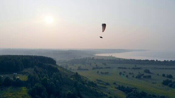 一个人在空中用滑翔伞飞行滑翔伞在天空