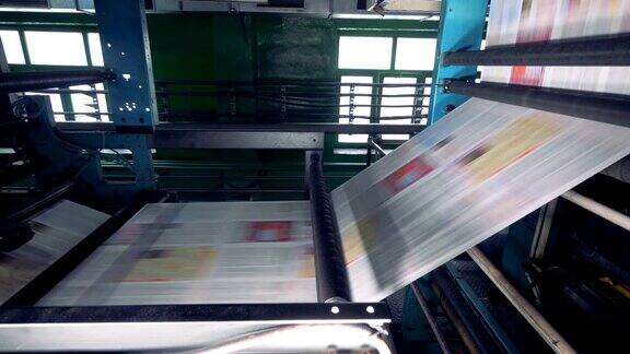 新印刷的报纸、杂志在印刷厂的流水线上移动