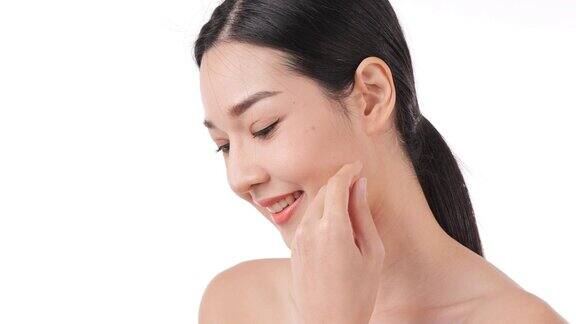 美丽的年轻亚洲女人的肖像触摸脸和健康的皮肤