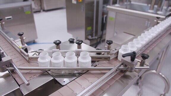 药品流水线上的空容器在制药生产公司塑料瓶在传送带上移动