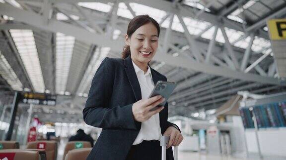 女商人在机场使用智能手机