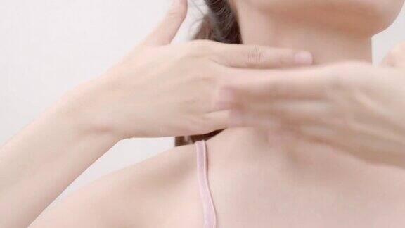 亚洲美女在脖子上涂抹保湿霜医疗保健化妆品美容产品