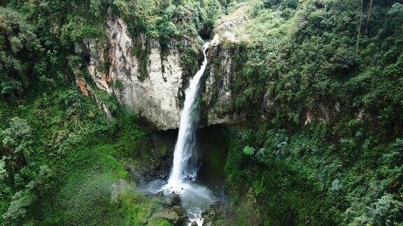 景观无人机镜头高泡沫瀑布通过岩石悬崖在森林