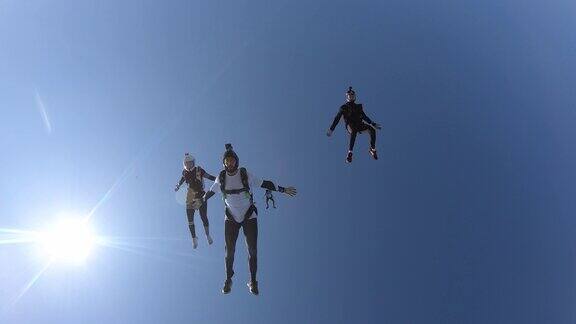 在阳光明媚的日子里跳伞者在自由落体时表演杂技