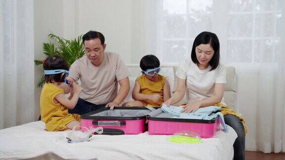 亚洲家庭为旅游准备衣服行李概念放松旅行冒险
