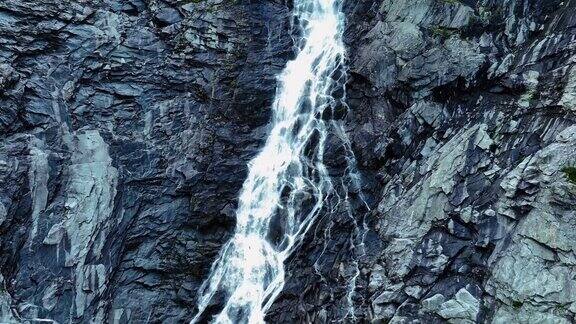 流经高高的岩石山的瀑布景观