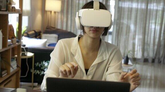亚洲人在家使用虚拟现实模拟器工作