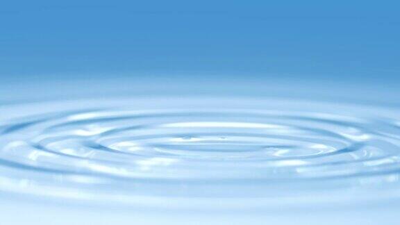 概念宏观慢动作水滴在清水化妆蓝色背景