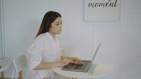 亚洲女商人在咖啡馆用笔记本电脑工作