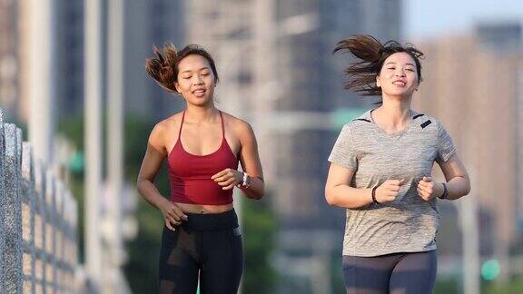 两个女人在城市大桥上慢跑