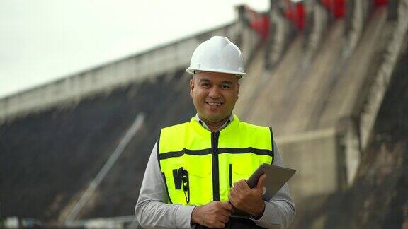 专业的亚洲维修工程师头戴安全帽在水电站大坝和灌溉工地工作在大型建筑项目工作的经理工程师