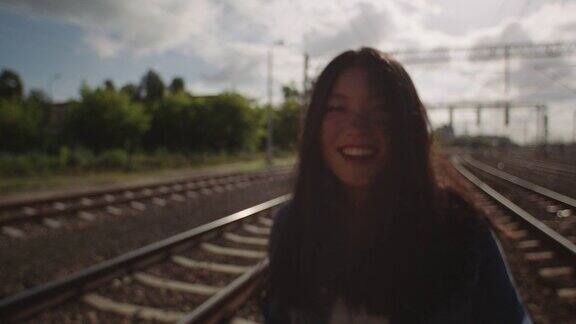 亚洲年轻女子在铁路上抛洒头发
