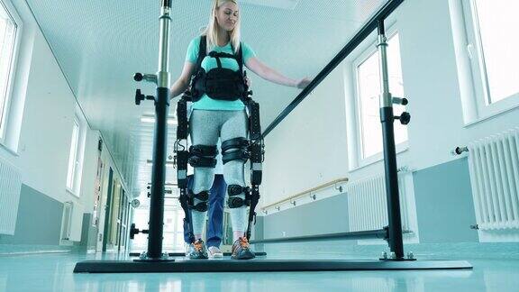 一位女士在医疗帮助下穿着防护服学习走路
