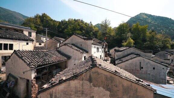 中国老安徽风格的砖瓦屋顶房屋以山为背景的春天