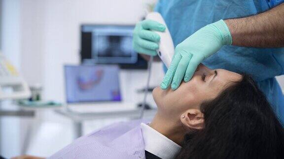 牙科医生扫描女性病人牙齿