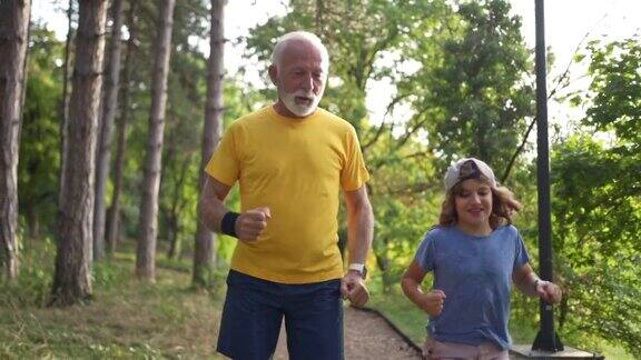 在森林里爷爷和孙子慢跑在娱乐活动中有一个纽带