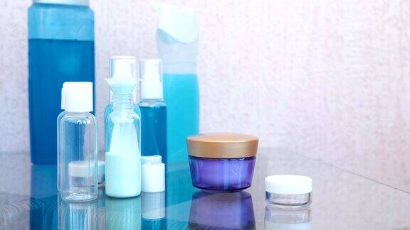 用漏斗将蓝色洗发水倒入大瓶小瓶中旅行套罐子化妆品的特写镜头