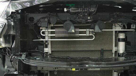 汽车引擎盖下的散热器敞篷汽车打开引擎盖的汽车电池新车发动机的细节